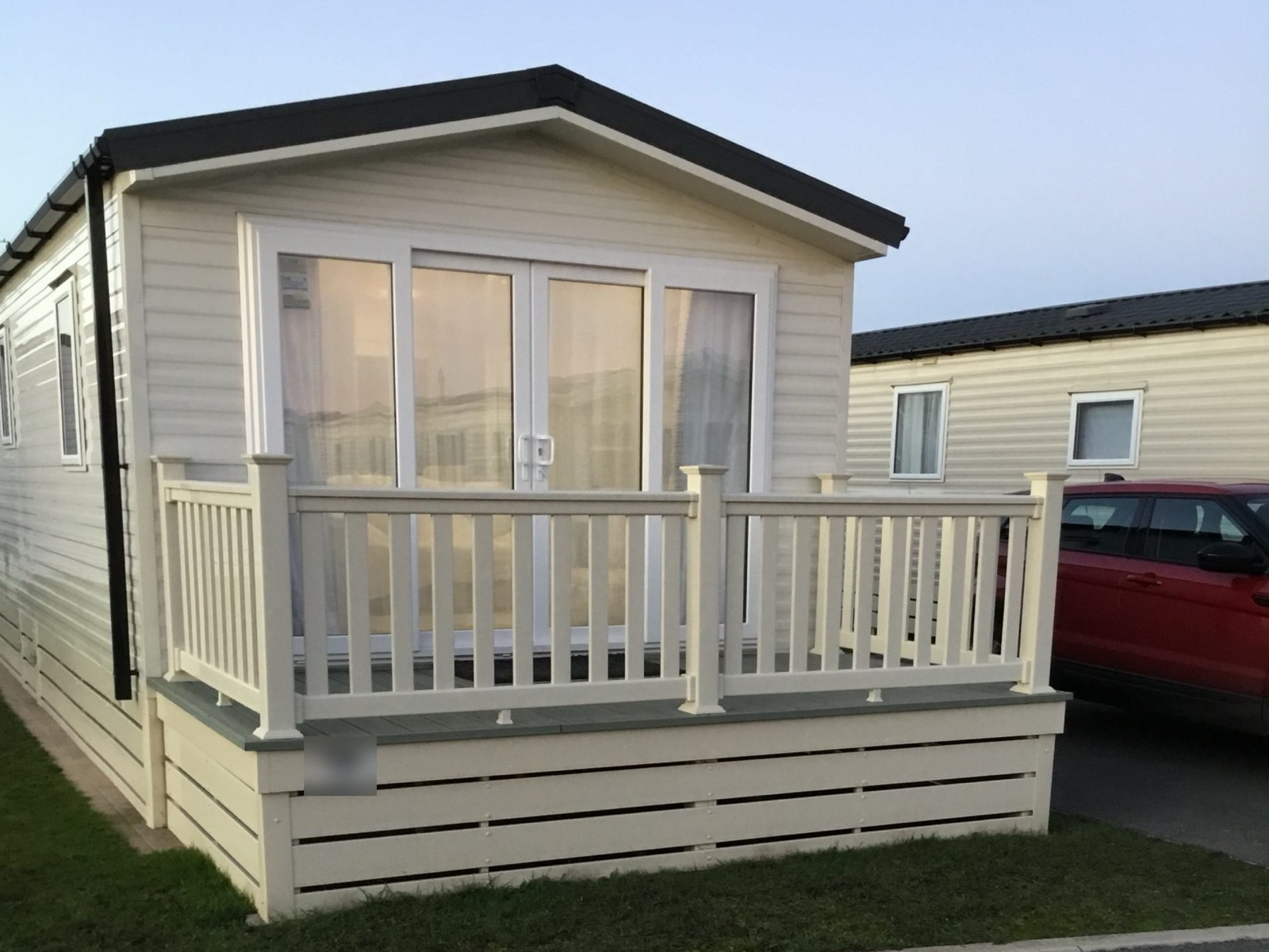 The front of the holiday home, with its decking and patio doors