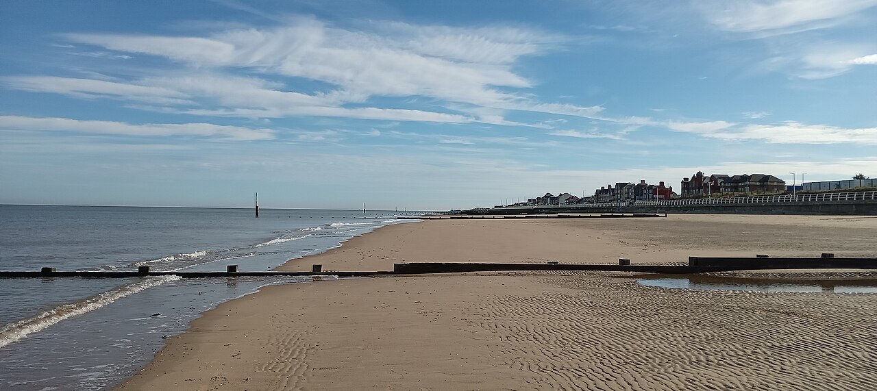 Rhyl beach and its groynes, with the seafront buildings beyond